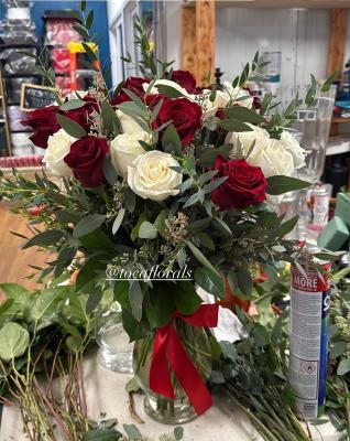 12 white roses, 12 red roses, seeded eucalyptus, greens in a glass vase with red ribbon