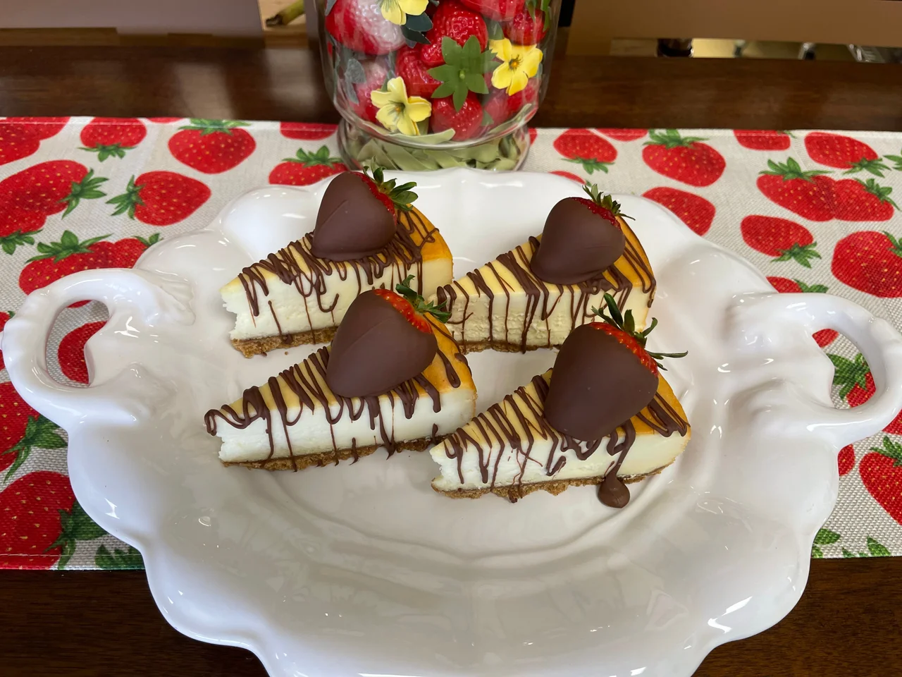 Chocolate drizzled cheesecake with chocolate dipped strawberry